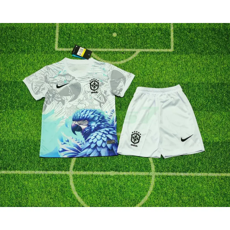 Camiseta Brasil 2026 Edición Especial con Estampado de Loro Blanco/Azul Niño Kit Camiseta Brasil 2026 Edición Especial con Estampado de Loro Blanco/Azul Niño Kit